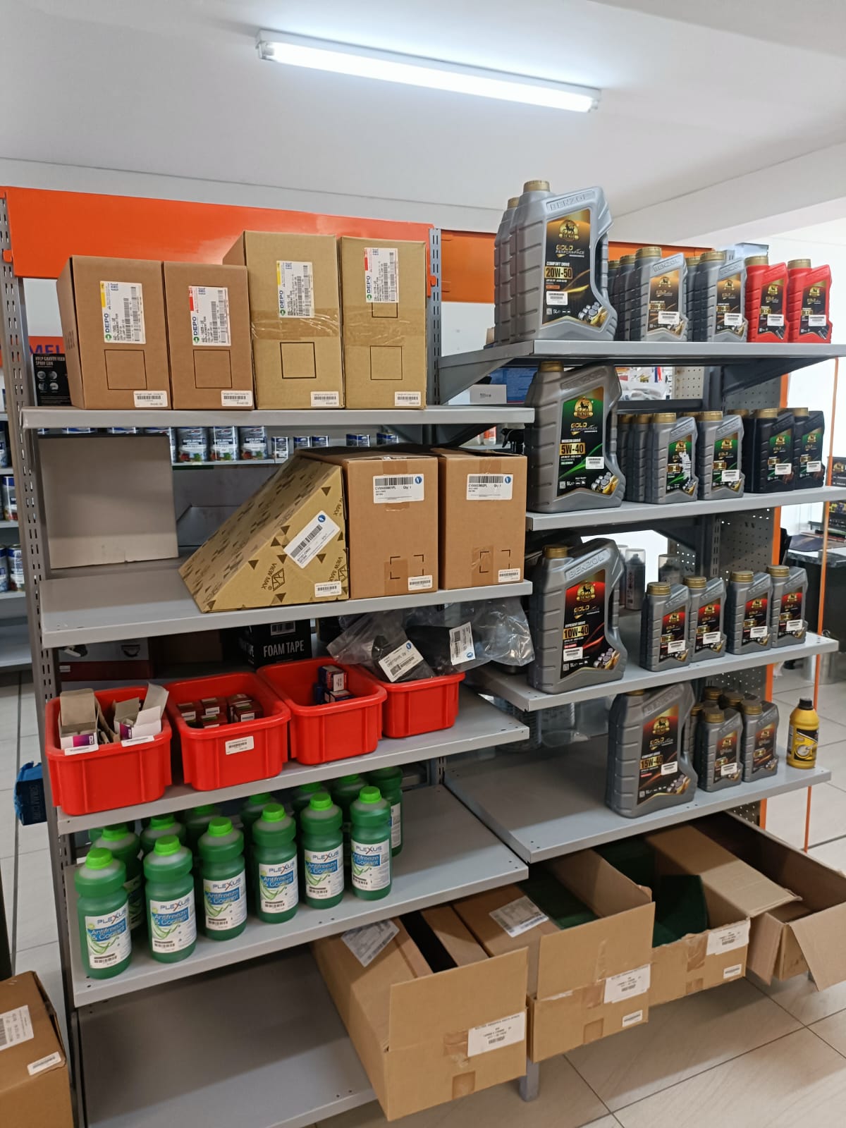 Shelving with lubricants, boxed parts, and coolant products inside Auto Stop Paints and Parts