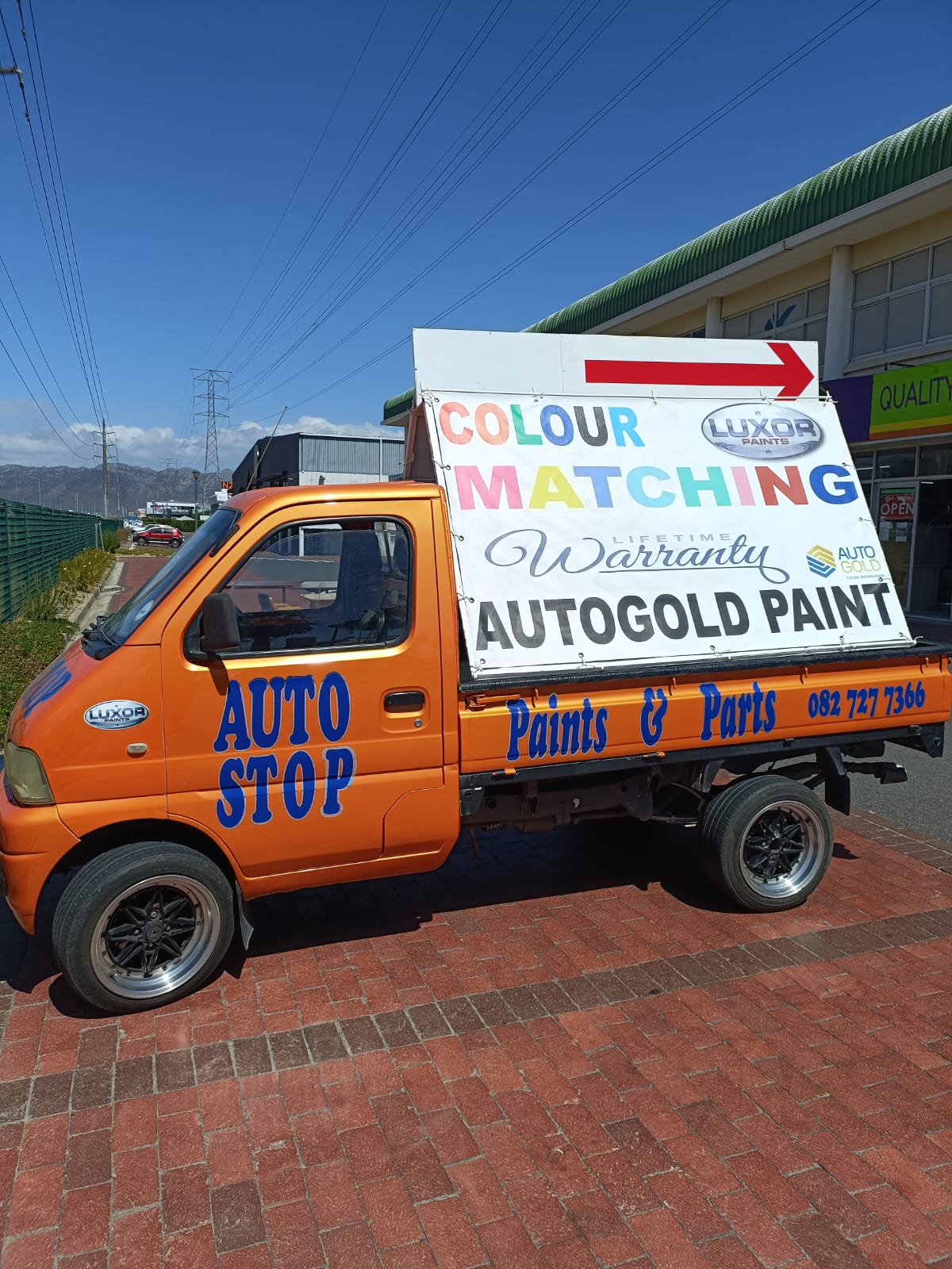 Auto Stop Paints and Parts branded vehicle outside the store